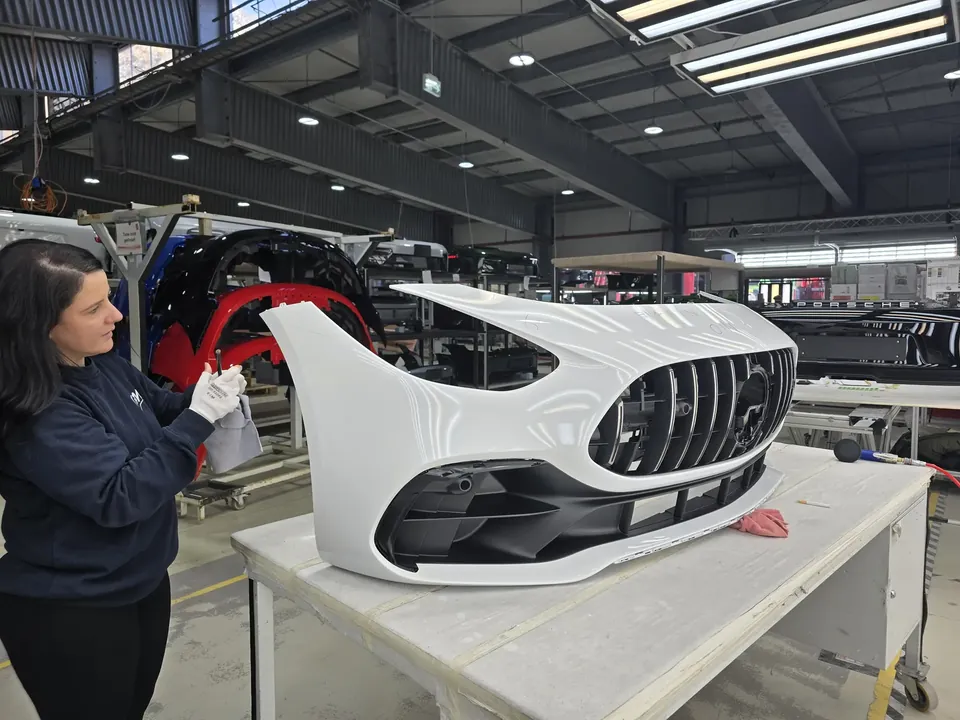 AP Neves quality inspector checking a painted bumper on a production line