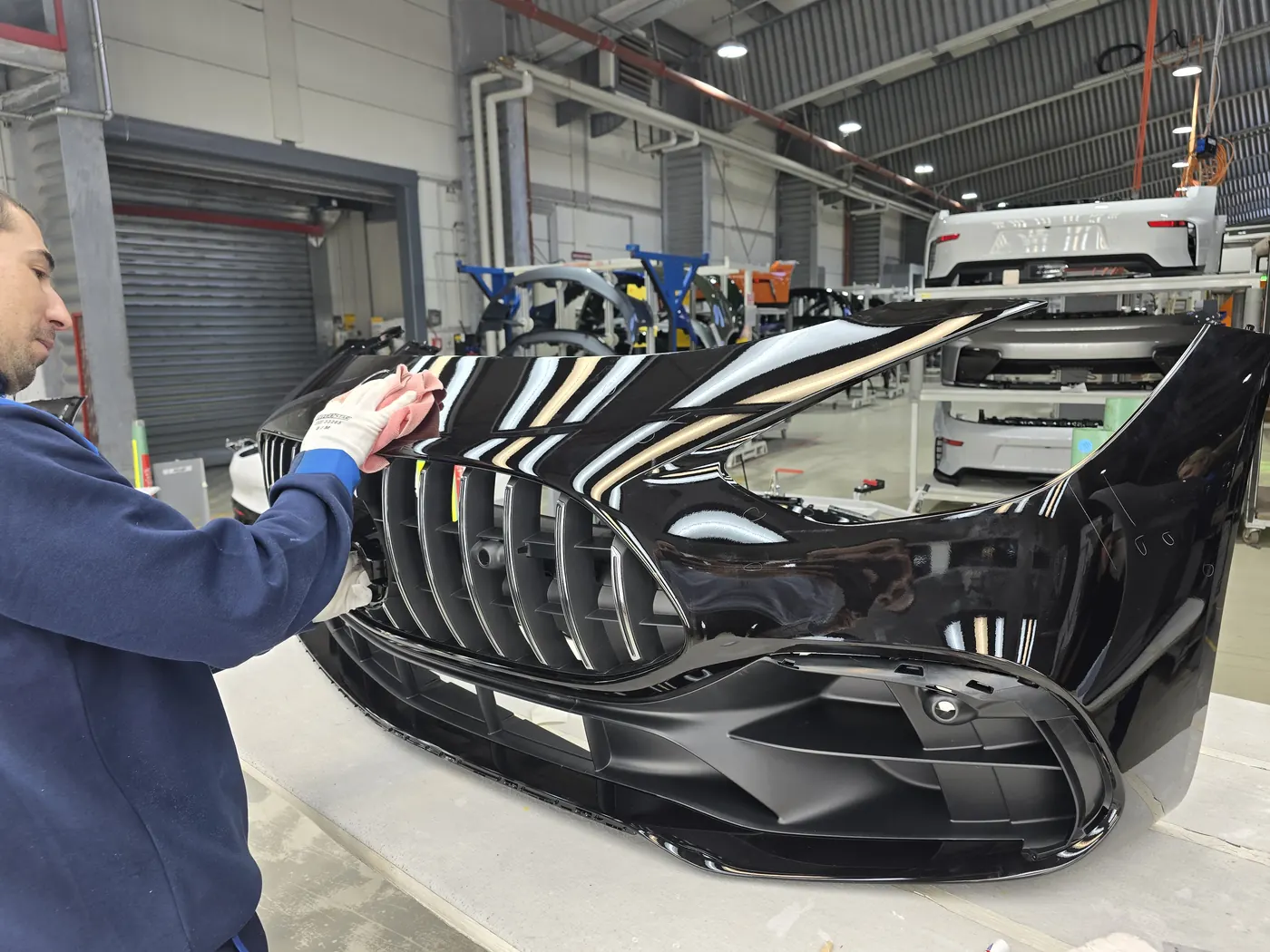 AP Neves worker preparing a painted car part
